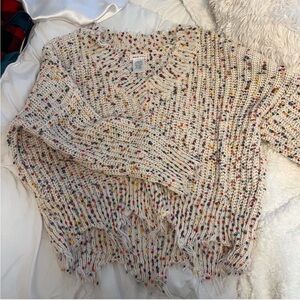 Cream and multi color knit sweater with distressed hem. Main strip; size Small